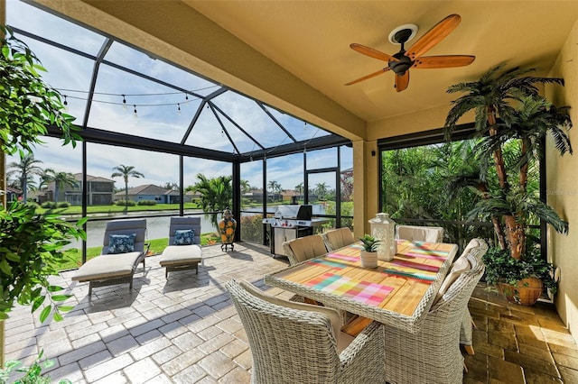 view of patio / terrace with glass enclosure, ceiling fan, and area for grilling