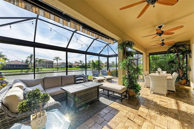 view of patio with a lanai, an outdoor living space, and a water view