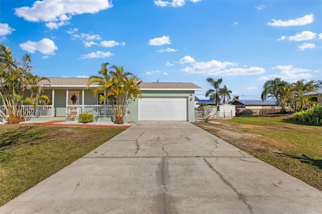 ranch-style home with covered porch, a garage, and a front yard