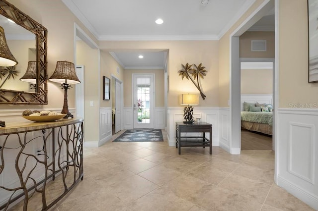 entryway featuring crown molding