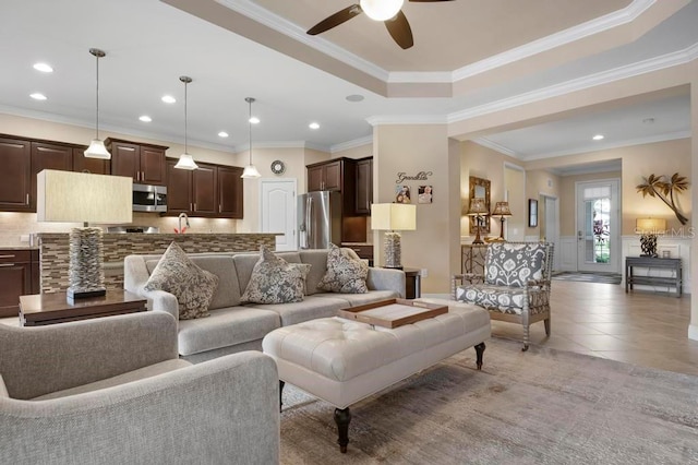 living room with ceiling fan, light tile patterned floors, and ornamental molding