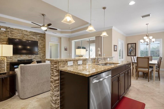 kitchen with a raised ceiling, hanging light fixtures, sink, and stainless steel dishwasher