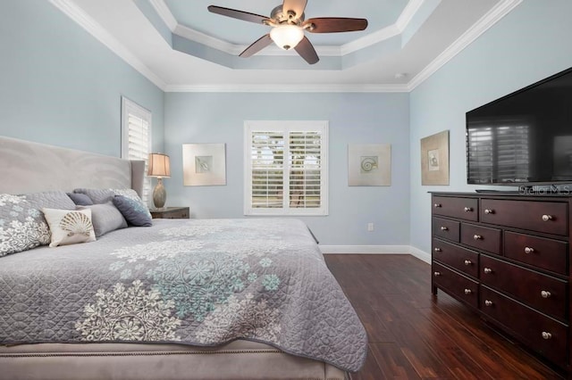 bedroom featuring multiple windows, a raised ceiling, and ceiling fan