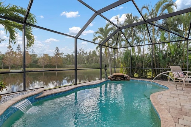 view of pool featuring pool water feature, a water view, glass enclosure, and a patio area