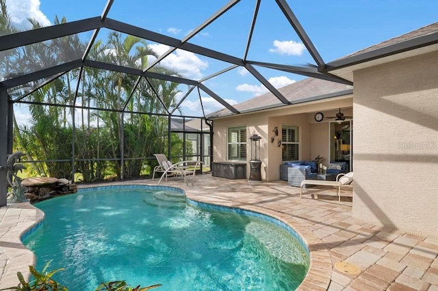 view of swimming pool with a lanai, ceiling fan, and a patio