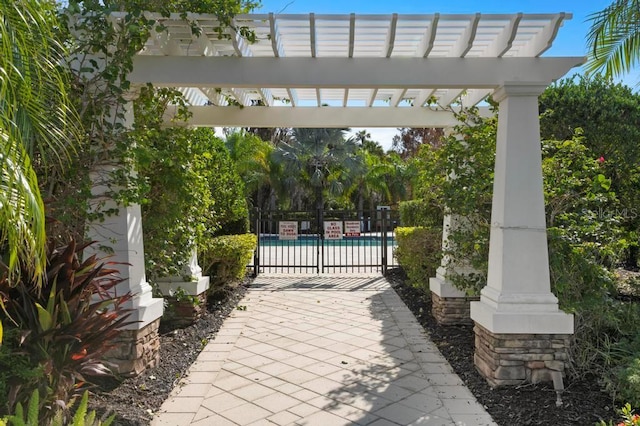 view of patio featuring a pergola and a community pool