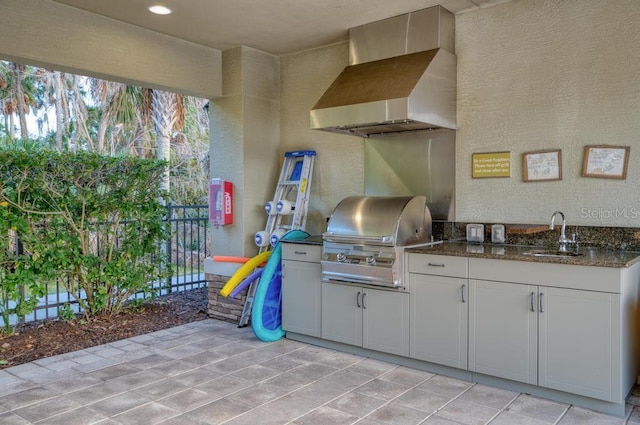 view of patio with an outdoor kitchen, sink, and grilling area