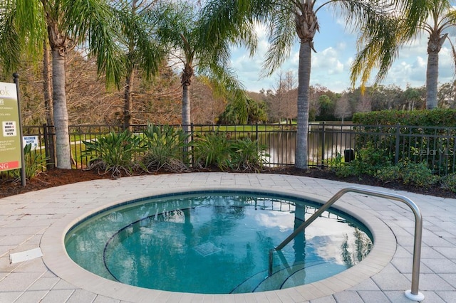 view of swimming pool featuring a water view