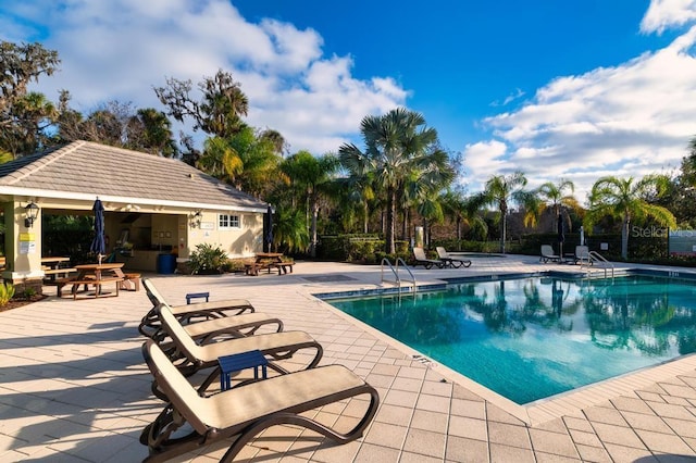 view of swimming pool with a patio