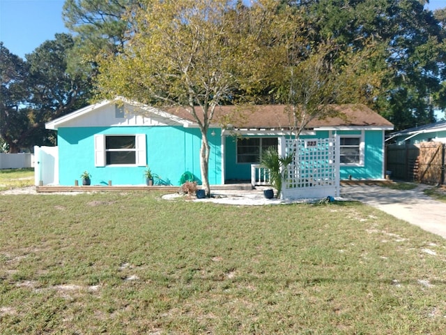 ranch-style house with a front lawn and covered porch