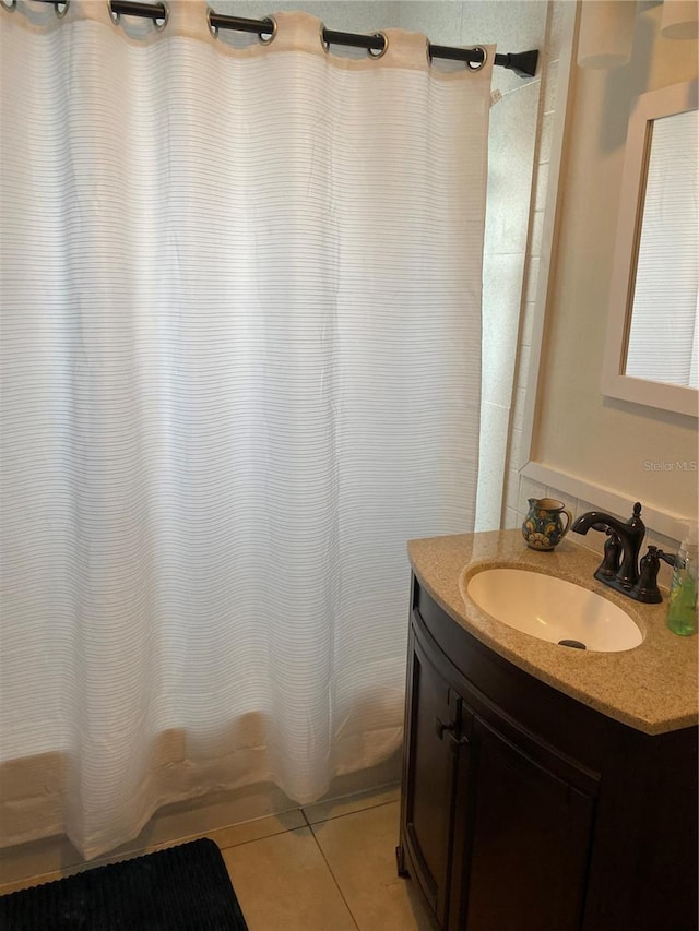 bathroom featuring tile patterned flooring, shower / bath combination with curtain, and vanity