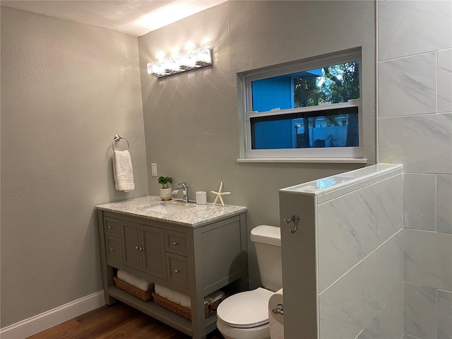 bathroom featuring hardwood / wood-style floors, vanity, and toilet