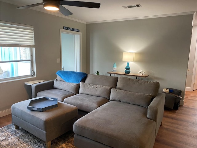 living room with hardwood / wood-style flooring, ceiling fan, and crown molding