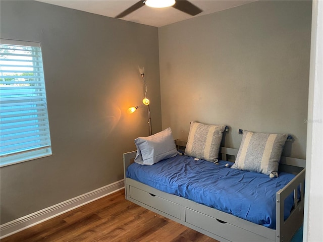 bedroom featuring ceiling fan and dark hardwood / wood-style flooring