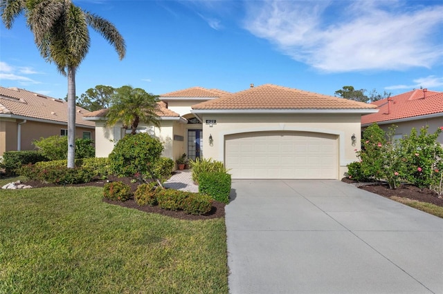 mediterranean / spanish-style home featuring a garage and a front lawn