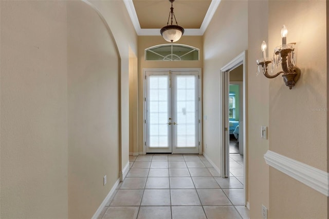 foyer entrance featuring crown molding, french doors, and light tile patterned floors