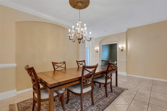 tiled dining room featuring a chandelier and ornamental molding