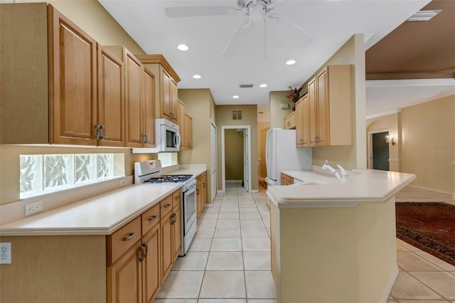 kitchen featuring kitchen peninsula, white appliances, ceiling fan, light brown cabinets, and light tile patterned flooring