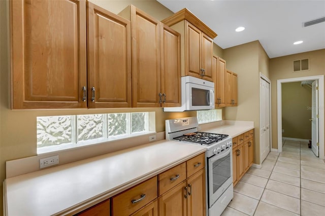 kitchen featuring light tile patterned floors and white appliances