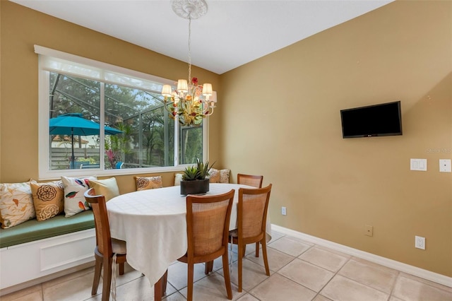 dining room with light tile patterned floors and an inviting chandelier