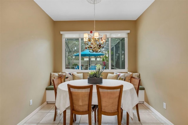 tiled dining space featuring an inviting chandelier