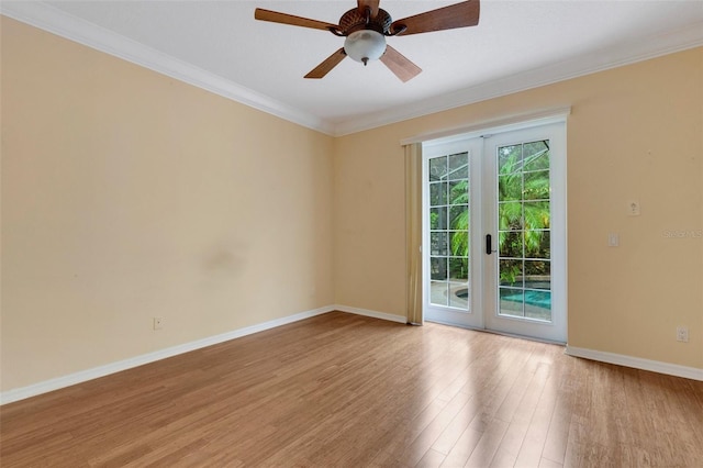 spare room featuring french doors, light hardwood / wood-style floors, ceiling fan, and ornamental molding