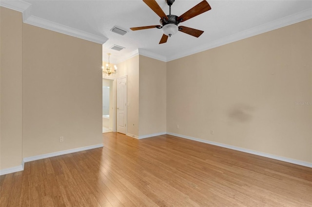 empty room with ceiling fan with notable chandelier, light wood-type flooring, and crown molding