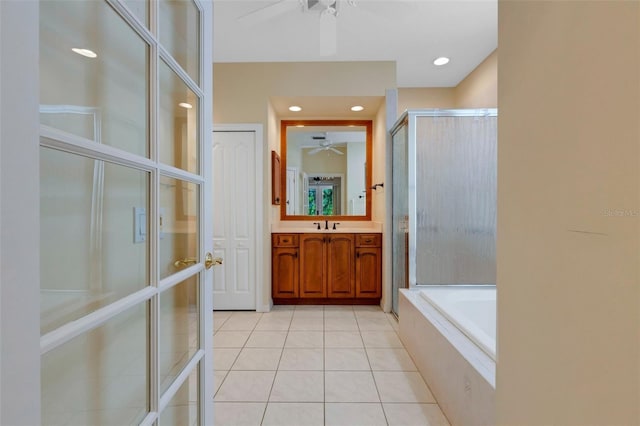 bathroom with tile patterned floors, vanity, and plus walk in shower