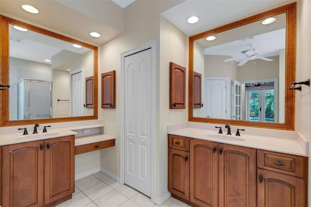 bathroom featuring vanity, a shower with door, tile patterned floors, and ceiling fan