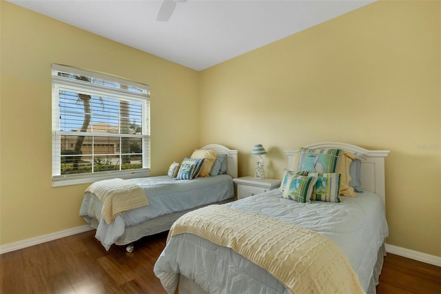 bedroom with ceiling fan and dark hardwood / wood-style floors