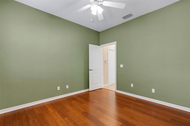 spare room featuring hardwood / wood-style floors and ceiling fan