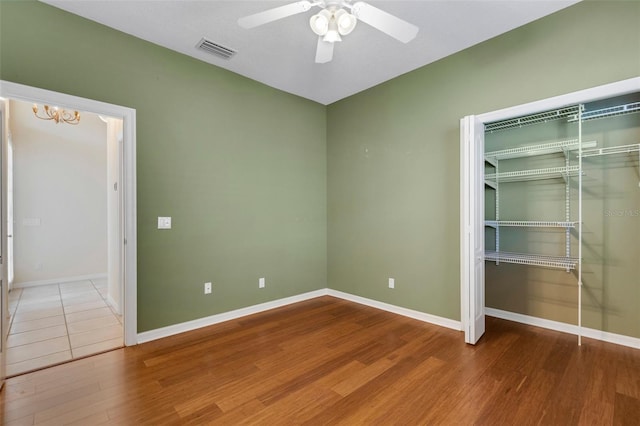 spare room with hardwood / wood-style flooring and ceiling fan