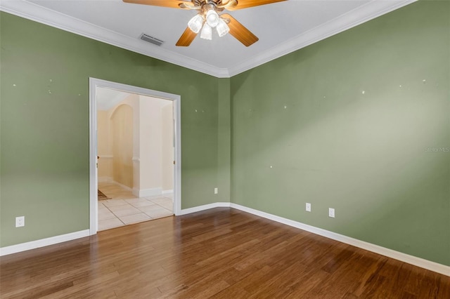 spare room with light hardwood / wood-style flooring, ceiling fan, and ornamental molding