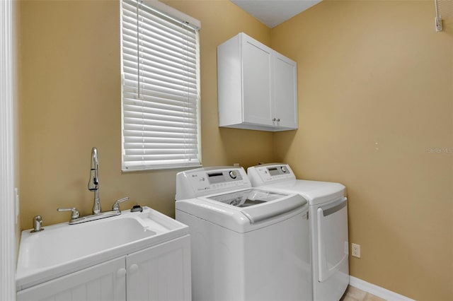 laundry area featuring washer and dryer and cabinets