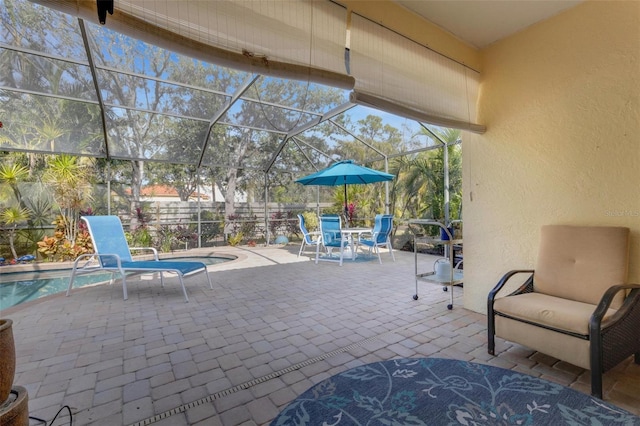 view of patio featuring a fenced in pool and glass enclosure