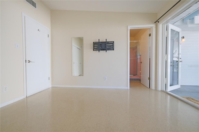 unfurnished room with visible vents and baseboards