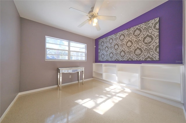 unfurnished room with ceiling fan and baseboards