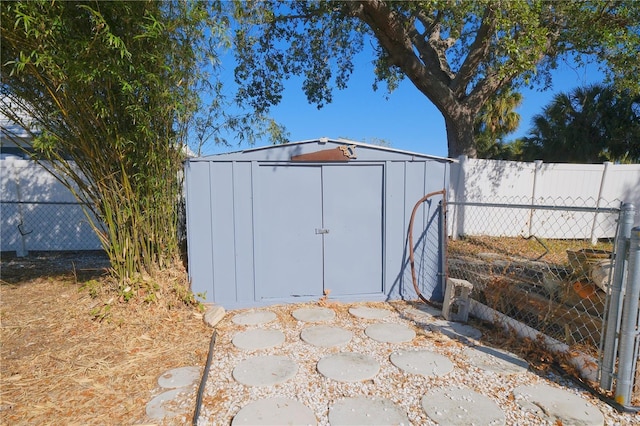 view of shed featuring fence