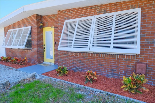 property entrance with brick siding