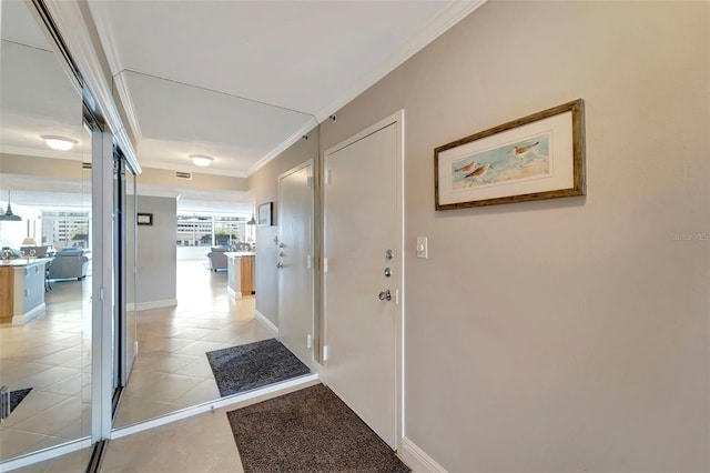 hallway with light tile patterned flooring and crown molding