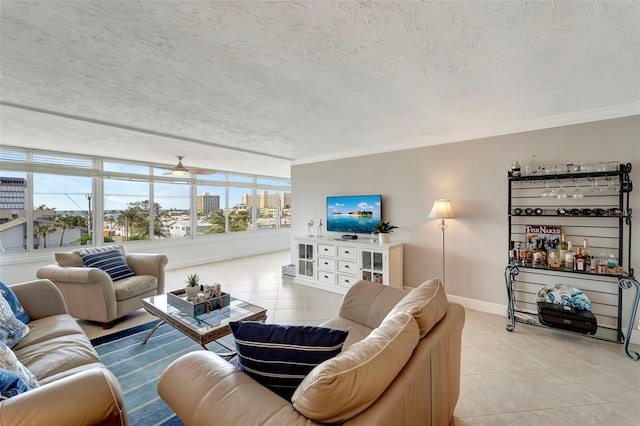 living room featuring light tile patterned floors, a textured ceiling, ceiling fan, and crown molding