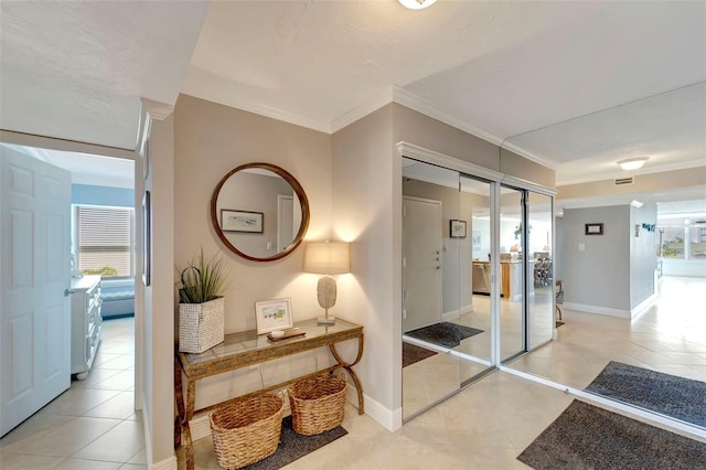 hallway featuring light tile patterned floors and crown molding