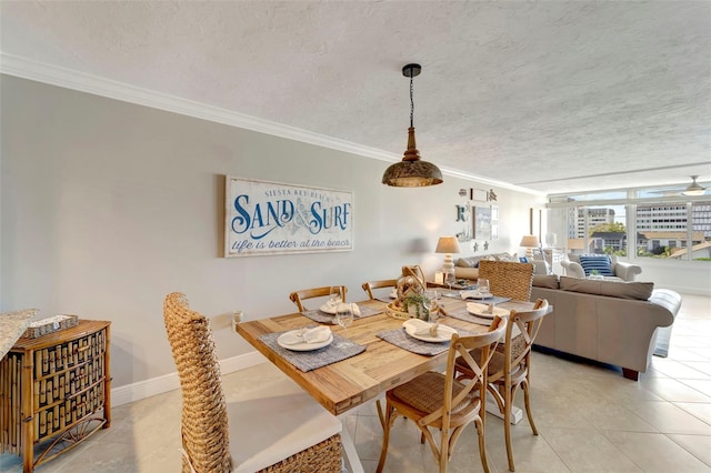 dining area featuring a textured ceiling, light tile patterned floors, and ornamental molding