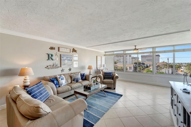 tiled living room featuring ceiling fan, ornamental molding, and a textured ceiling