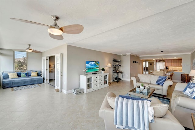 living room featuring ceiling fan and a textured ceiling