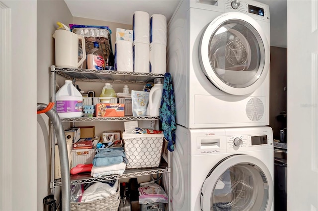 laundry area with stacked washer and clothes dryer