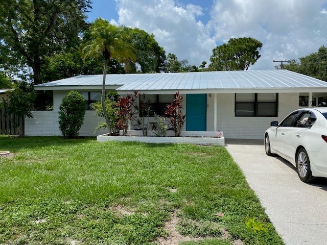 ranch-style house with a front lawn, covered porch, and a carport