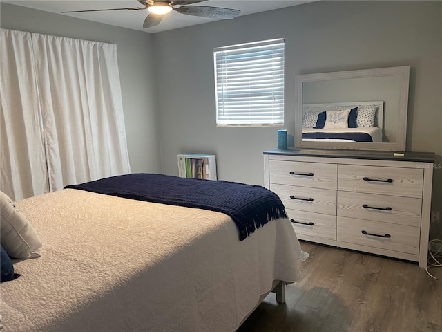 bedroom with ceiling fan and dark hardwood / wood-style floors