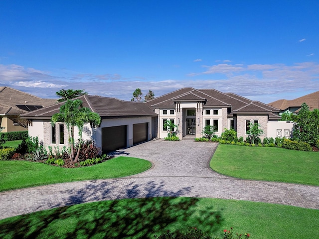 prairie-style home with a garage and a front yard