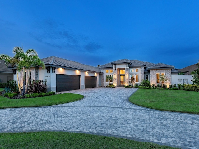 view of front facade with a lawn and a garage